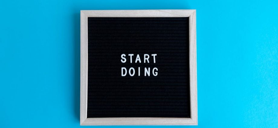 Black letter board with 'START DOING' text on a vibrant blue background.